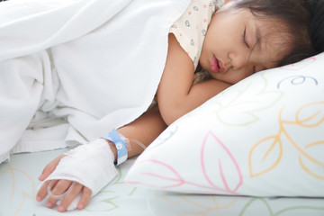 Asian child or kid girl patients sleep rest on bed or sick and headache with feverish in pediatric...