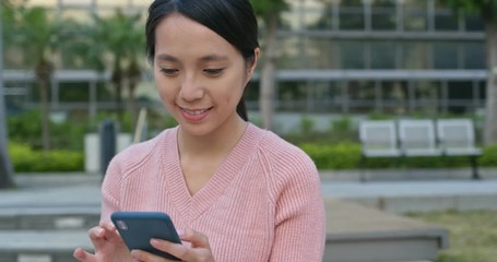Woman use of mobile phone at outdoor