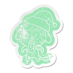 cute cartoon distressed sticker of a dog wearing santa hat