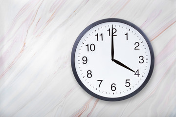 Wall clock show four o'clock on marble texture. Office clock show 4pm or 4am on marble texture with...