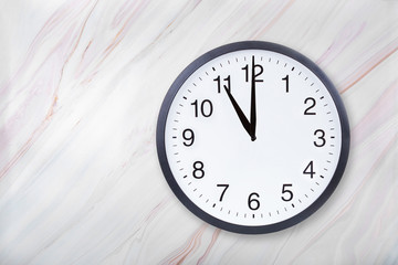 Wall clock show eleven o'clock on marble texture. Office clock show 11pm or 11am on marble texture with natural pattern