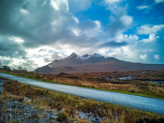 View of the Black Cuillin mountain range on the Isle of Skye with snow seen from the protree road