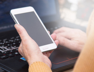 woman working with laptop and mobile phone