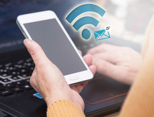 Woman using computer and mobile phone