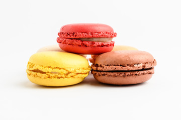 Close up of group of three sweet French macarons isolated on white, pastel colors
