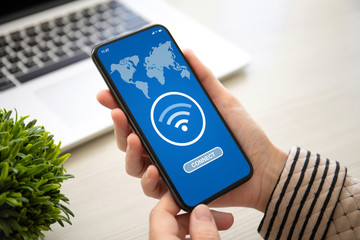 female hands holding phone with app wifi connect on screen