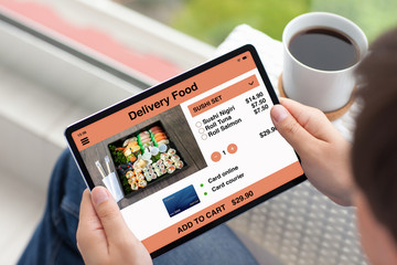 man hands holding tablet computer with app delivery food