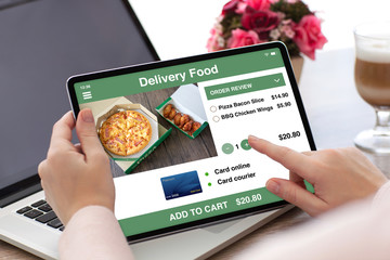 woman hands holding tablet computer with app delivery food
