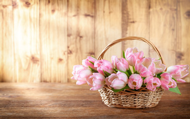Easter holiday basket with beautiful pink tulips.
