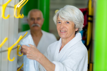 senior woman in bathrobe at a changing room