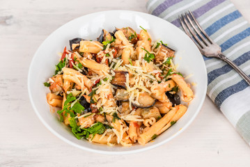 Rustic italian vegetarian pasta with fried eggplants and tomatoes.