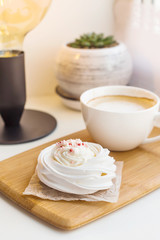 Low-calorie dessert Pavlova with a cup of coffee