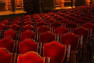 Interior theater art. Audience with empty soft armchairs of Opera and Ballet Theater is waiting for audience. Empty interior of concert theater before performance and without spectators. Soft focus