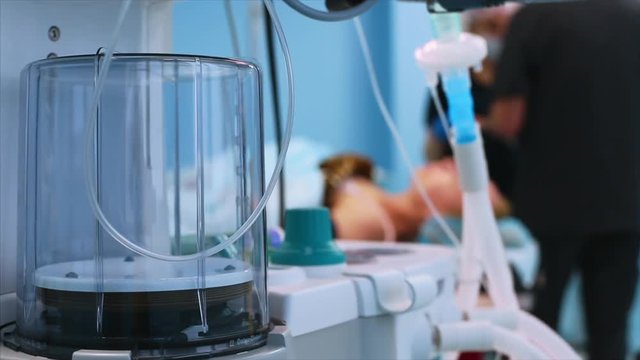 Operating room, patient preparation for surgery. Anesthesiologist with nurse prepares the patient for anesthesia view from the ventilator