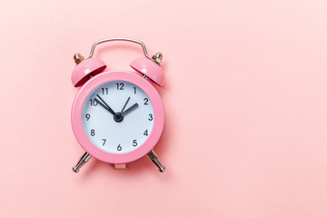 Ringing twin bell vintage classic alarm clock Isolated on pink pastel colorful trendy background....