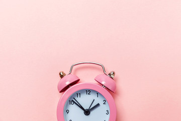 Ringing twin bell vintage classic alarm clock Isolated on pink pastel colorful trendy background....