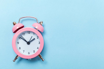Ringing twin bell vintage classic alarm clock Isolated on blue pastel colorful trendy background....