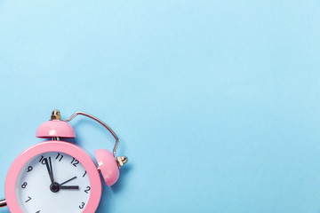 Ringing twin bell vintage classic alarm clock Isolated on blue pastel colorful trendy background....