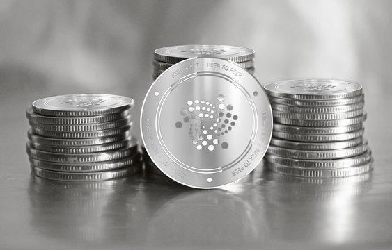Iota (IOT) digital crypto currency. Stack of silver coins. Cyber money.