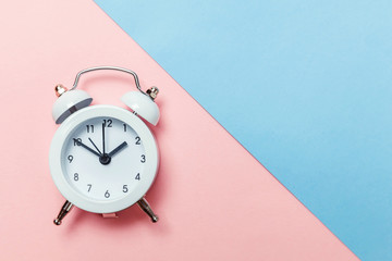 Ringing twin bell vintage classic alarm clock Isolated on blue pink pastel colorful trendy...