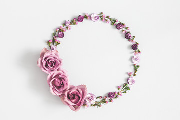 Flowers composition. Wreath made of purple flowers on gray background. Flat lay, top view, copy space