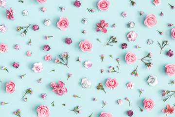 Flowers composition. Pattern made of pink flowers on pastel blue background. Flat lay, top view