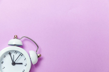 Ringing twin bell vintage classic alarm clock Isolated on purple violet pastel colourful...
