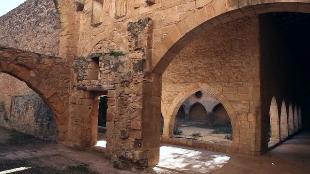 Strict architecture of cloister gallery with Gothic ogival spans of Monastery of Santa Maria de Santes Creus, Catalonia, Spain
