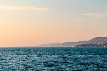 Fototapeta premium Colorful sunset in front of the city of Trieste