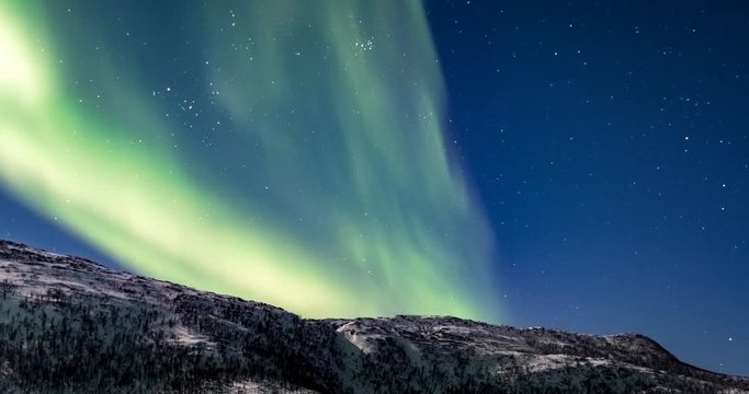 Northern Lights, polar light or Aurora Borealis in the night sky over Senja island in Northern Norway time lapse.