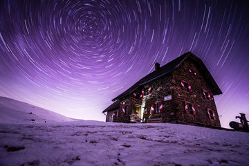 Night sky star trails above Wolfsberger hut, Wolfsberg, Carinthia, Austria