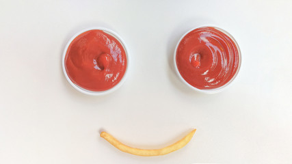 Two Tomato Sauces And fried potatoes The composition is a smiley face.