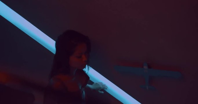 Sensual beautiful woman wearing red lace lingerie in her luxurious apartment at night - video in slow motion