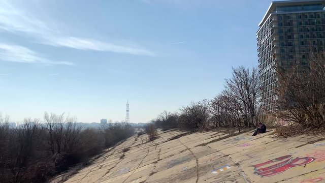 Man reads near Vacaresti lake in Bucharest, Romania