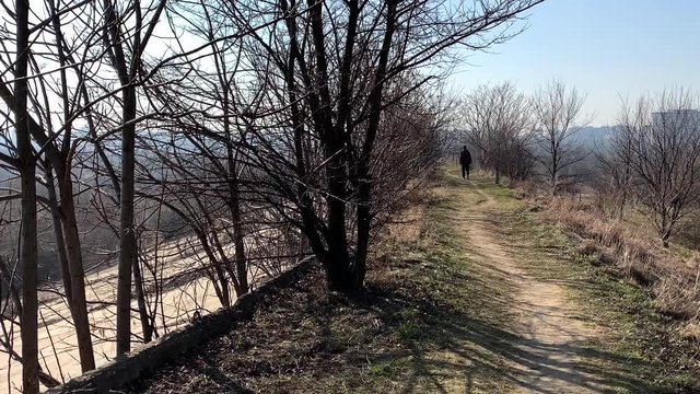 Man walks along the Vacaresti lake in Bucharest, Romania