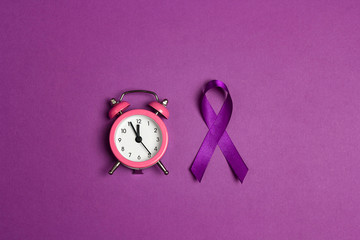 Purple epilepsy awareness ribbon with alarm clock on a purple background. World epilepsy day