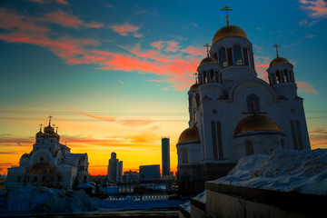 Wide angle view of soviet monument and church in Yekaterinburg at sunset