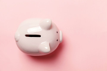Saving investment budget wealth retirement financial money banking concept. Pink piggy bank isolated on pink pastel colourful trendy background. Flat lay top view copy space