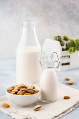 Bottle of nut milk and raw almonds. Alternative milk.