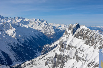 Fototapeta na wymiar Winter landscape from mount Titlis over Engelberg to the swiss alps