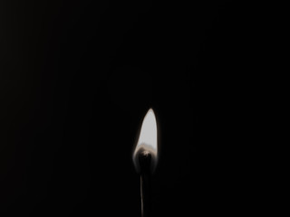 burning match on black background
