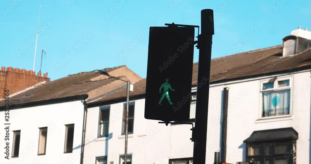 Poster traffic lights changing from a pedestrians point of view stood waiting to cross
