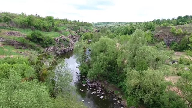 Ukrainian canyon in the village of Buki bird's-eye view. Drone removes from the height of the canyon of the Buka River, white cliffs, meadows, trees.