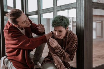 Angry husband holding neck of his helpless crying wife