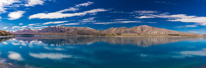 Fototapeta na wymiar Lake Tekapo with reflection of sky and mountains, New Zealand