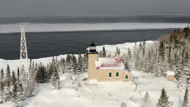 Beautiful Lighthouse on winter landscape. Overlooking Lake Superior one of the USA's Great Lakes.