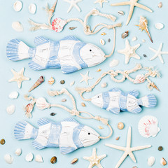 Decorative fish with Seashells and starfish on a pastel background. Summer time concept. Nautical pattern.