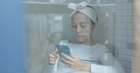 Woman apply the paper mask and use of mobile phone