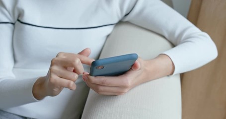 Woman use of smart phone and sit on the sofa