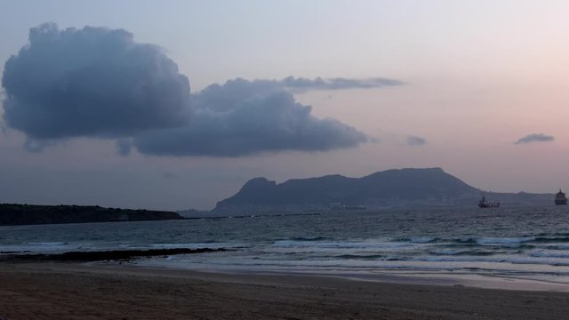 Various shots and angles of Gibraltar from Getares beach. Ships in the busy shipping lanes that enter Gibraltar. Location of frequent disputes between Spain and Gibraltar over ocean territories.